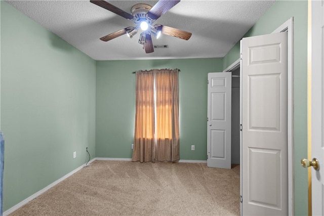 424 W Tanner Dr, Fayetteville, AR 72701 - unfurnished bedroom featuring a textured ceiling, carpet flooring, a ceiling fan, and baseboards
