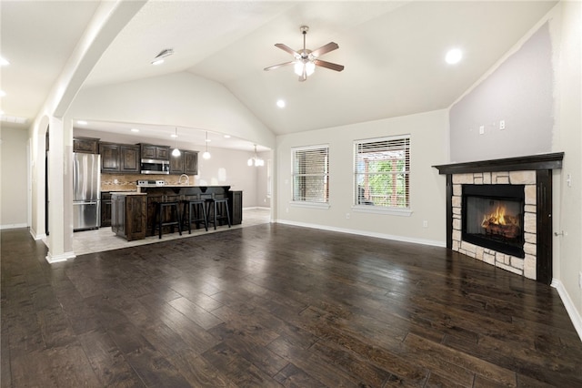 809 Sedgwick Dr, Prairie Grove, AR 72753 - unfurnished living room with recessed lighting, hardwood / wood-style floors, vaulted ceiling, ceiling fan, and a lit fireplace