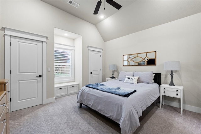 bedroom with light colored carpet, visible vents, vaulted ceiling, and baseboards