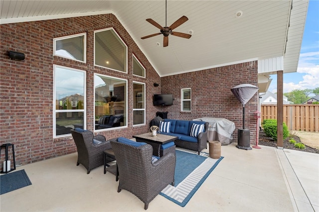 view of patio featuring fence, ceiling fan, and an outdoor living space