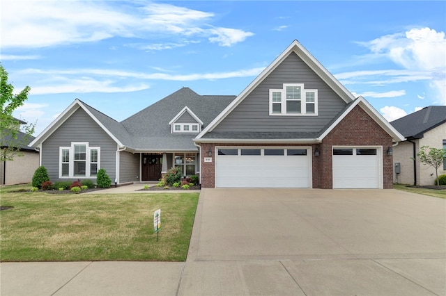 craftsman house with driveway, a front yard, brick siding, and a garage