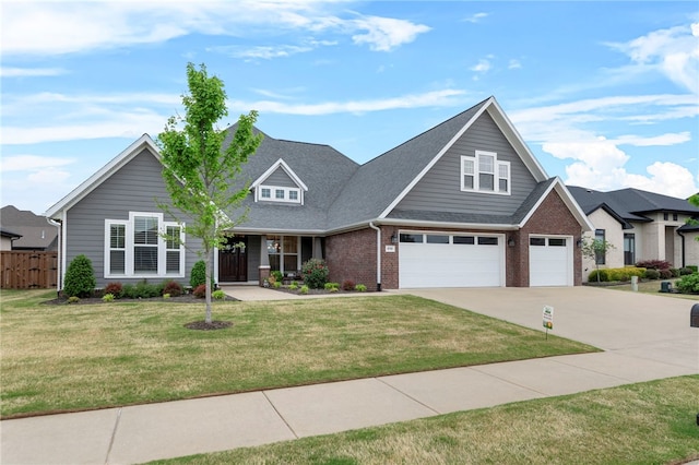 craftsman house featuring driveway, an attached garage, fence, brick siding, and a front lawn