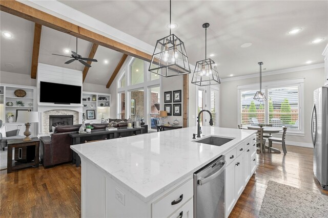 8705 Flycatcher Pl, Bentonville, AR 72713 - kitchen featuring a sink, stainless steel appliances, ceiling fan, an island with sink, and white cabinetry