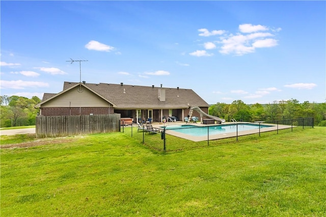 view of swimming pool featuring fence, a fenced in pool, and a lawn