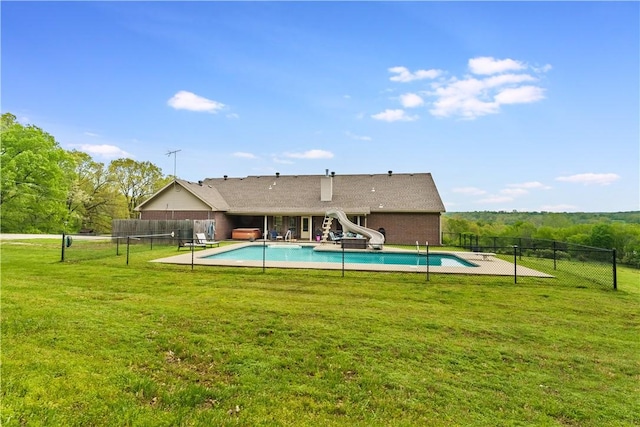 view of swimming pool featuring a fenced in pool, fence, and a yard