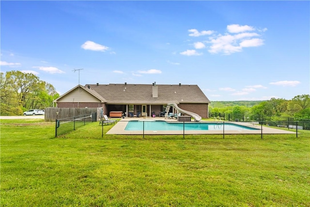 view of pool featuring a patio area, a fenced in pool, a yard, a water slide, and fence