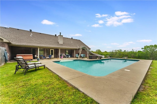 view of pool with fence, a fenced in pool, a water slide, a patio area, and a lawn