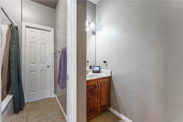full bathroom with baseboards, shower / bath combo, tile patterned flooring, and vanity