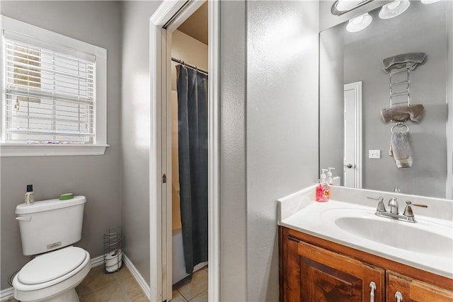 bathroom featuring baseboards, toilet, tile patterned flooring, and vanity