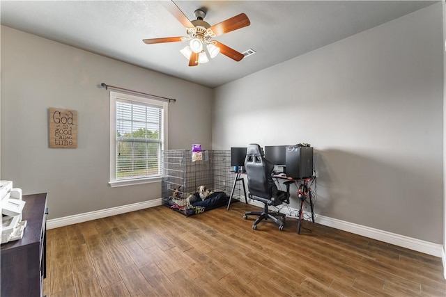 office featuring baseboards, visible vents, wood finished floors, and a ceiling fan