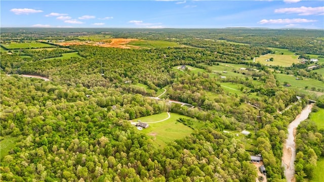 drone / aerial view featuring a wooded view