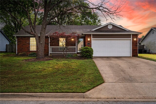 1600 N Stable Ave, Fayetteville, AR 72703 - single story home featuring a front lawn, concrete driveway, a porch, and brick siding