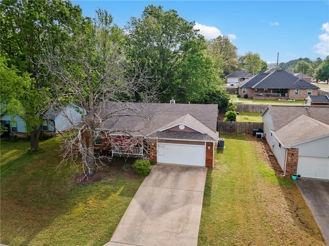 1600 N Stable Ave, Fayetteville, AR 72703 - view of front facade with a front lawn, a shingled roof, a residential view, concrete driveway, and fence