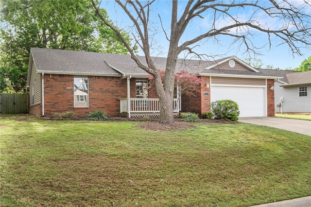 1600 N Stable Ave, Fayetteville, AR 72703 - ranch-style home featuring brick siding, fence, a garage, a front yard, and concrete driveway
