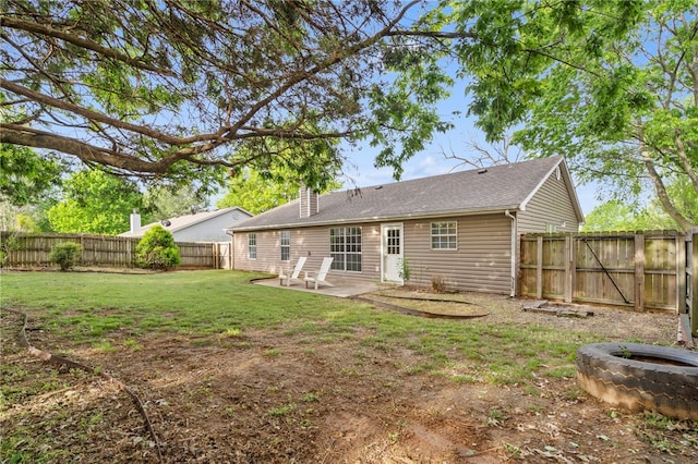 1600 N Stable Ave, Fayetteville, AR 72703 - back of house with a patio, a chimney, a fenced backyard, and a yard