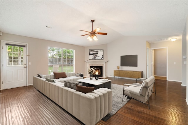 1600 N Stable Ave, Fayetteville, AR 72703 - living area with ceiling fan, visible vents, vaulted ceiling, wood finished floors, and a tiled fireplace