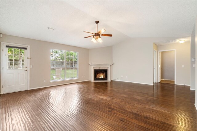 1600 N Stable Ave, Fayetteville, AR 72703 - unfurnished living room with wood finished floors, visible vents, a ceiling fan, a lit fireplace, and lofted ceiling