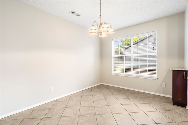 1600 N Stable Ave, Fayetteville, AR 72703 - empty room featuring an inviting chandelier, light tile patterned floors, visible vents, baseboards, and a textured ceiling