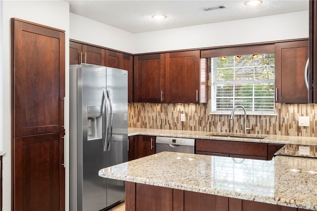 1600 N Stable Ave, Fayetteville, AR 72703 - kitchen featuring light stone counters, a sink, appliances with stainless steel finishes, visible vents, and backsplash