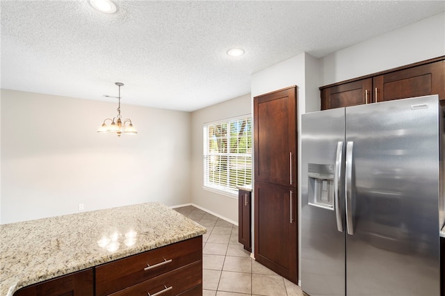 1600 N Stable Ave, Fayetteville, AR 72703 - kitchen with light tile patterned floors, stainless steel fridge, a textured ceiling, and hanging light fixtures