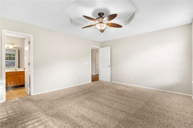 1600 N Stable Ave, Fayetteville, AR 72703 - unfurnished bedroom featuring baseboards, ensuite bathroom, a ceiling fan, and light colored carpet