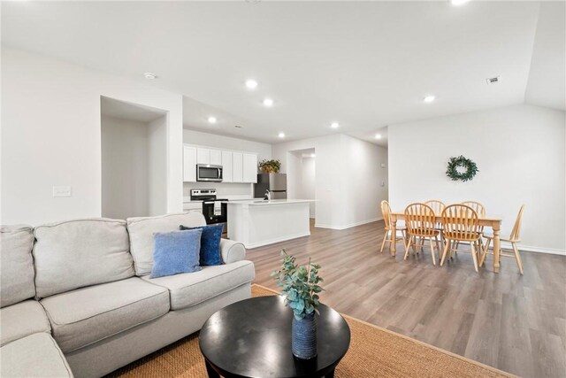 1300 Bates St, Gentry, AR 72734 - living room featuring light wood-style floors, recessed lighting, and baseboards
