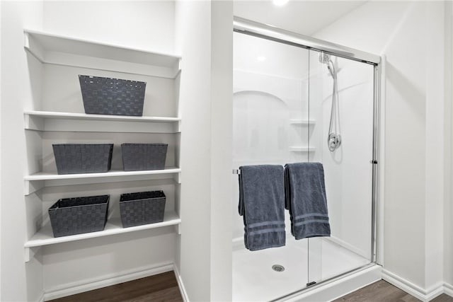 1300 Bates St, Gentry, AR 72734 - full bathroom featuring wood finished floors, a shower stall, and baseboards