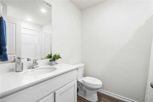 1300 Bates St, Gentry, AR 72734 - bathroom with wood finished floors, vanity, toilet, and baseboards