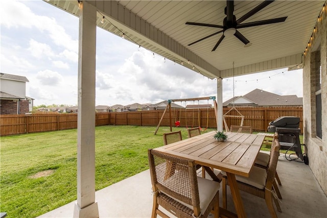 view of patio with a fenced backyard, a playground, outdoor dining space, a ceiling fan, and a grill