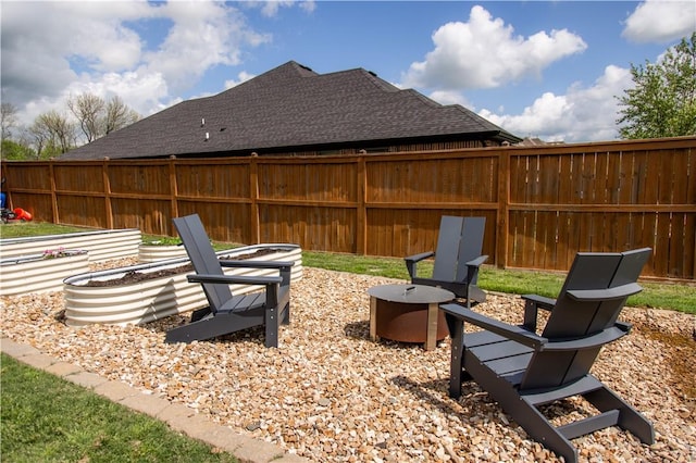 view of yard with fence and an outdoor fire pit