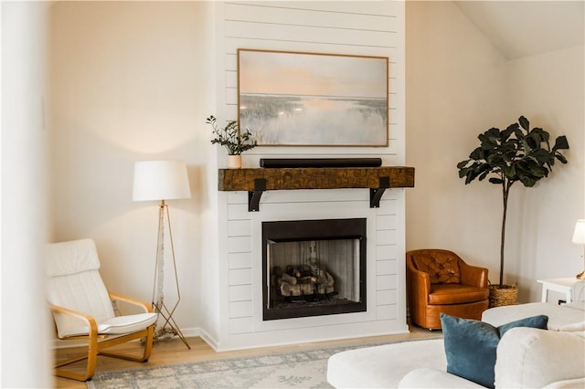living room with a fireplace and wood finished floors