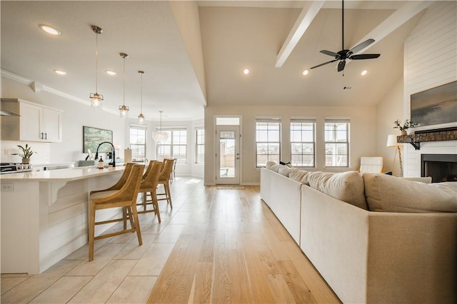 living room featuring recessed lighting, ceiling fan, lofted ceiling, and a fireplace