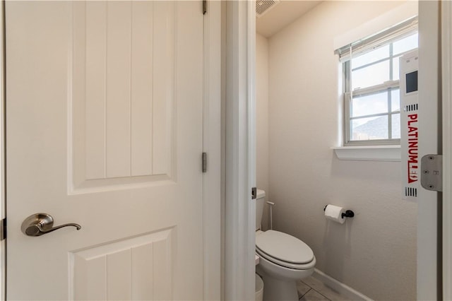 bathroom with visible vents, toilet, and baseboards