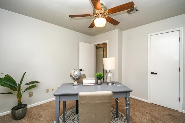 carpeted office space with visible vents, ceiling fan, and baseboards
