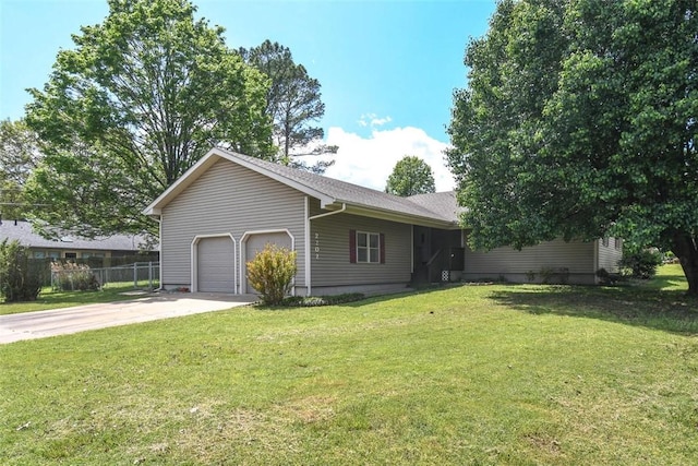 exterior space with a garage, fence, driveway, and a lawn