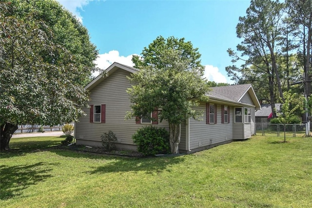view of home's exterior with a yard and fence