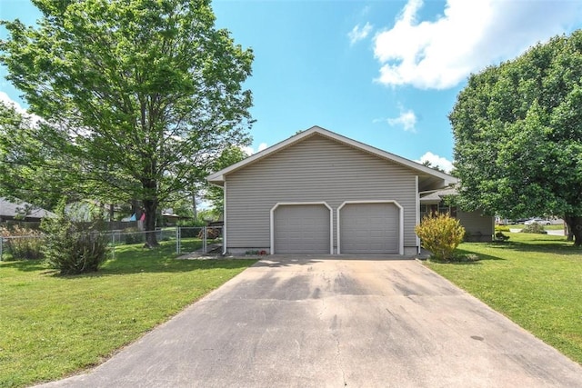exterior space featuring a front yard, concrete driveway, and fence