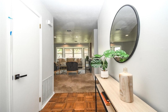 hall featuring recessed lighting and visible vents