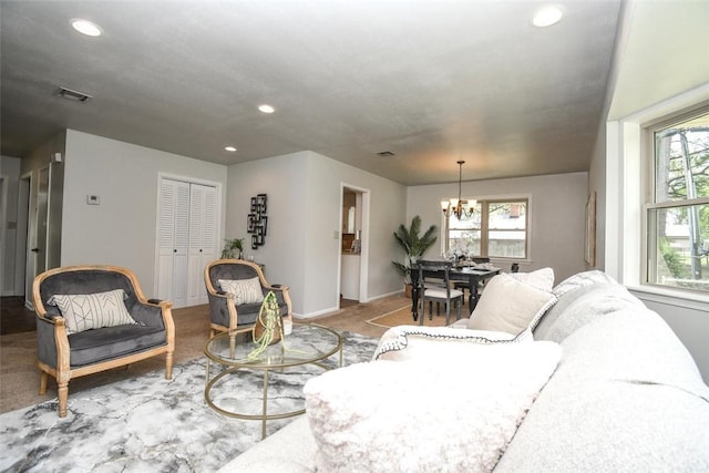 carpeted living area with a chandelier, visible vents, baseboards, and recessed lighting