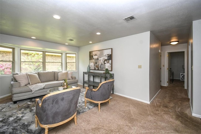 carpeted living room with baseboards, visible vents, and plenty of natural light