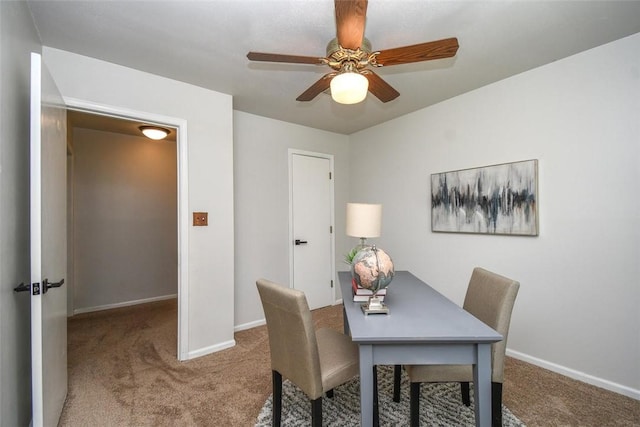 dining room with a ceiling fan, carpet flooring, and baseboards