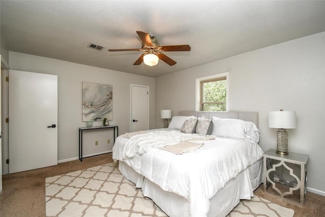 bedroom with light colored carpet, visible vents, and baseboards