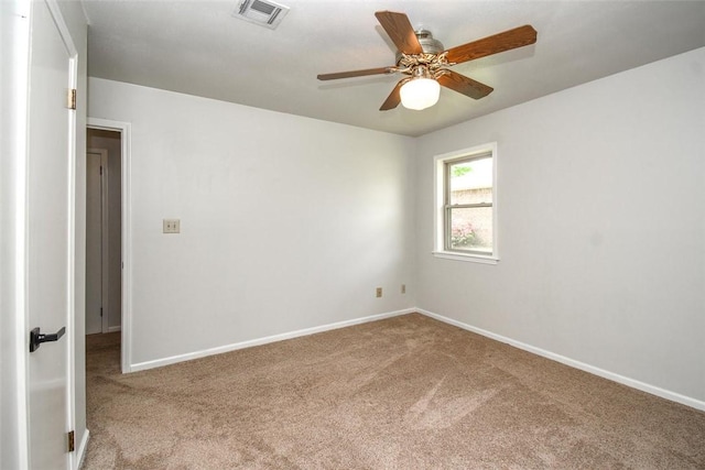 empty room featuring visible vents, baseboards, a ceiling fan, and carpet floors