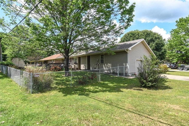 exterior space featuring fence, a lawn, and an attached garage