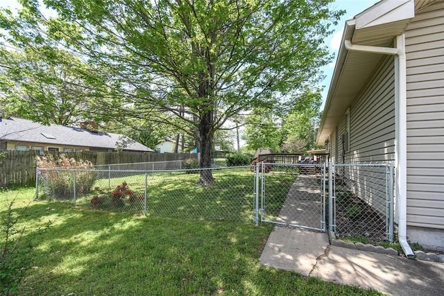 view of yard with fence and a gate