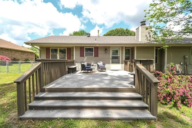 wooden deck with a lawn and fence