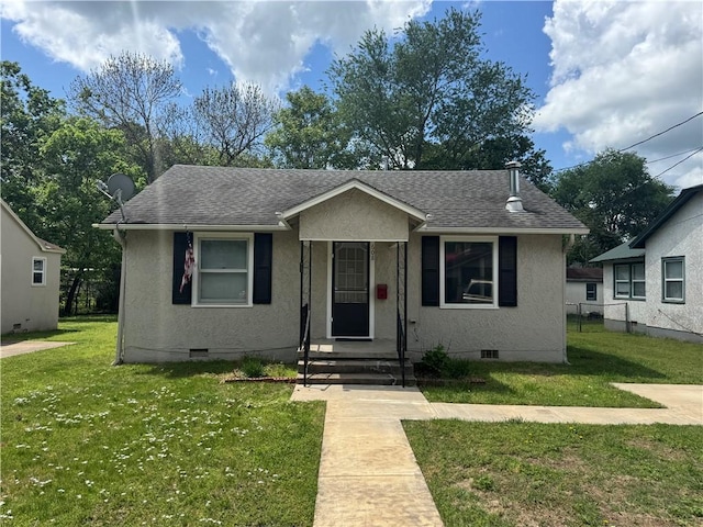 bungalow-style home with a front lawn, crawl space, a shingled roof, stucco siding, and fence