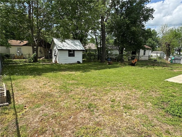 view of yard with an outbuilding, a storage shed, and a fenced backyard