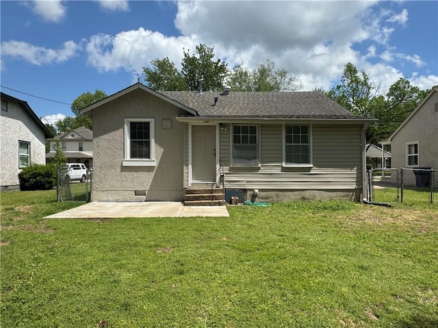 back of property featuring a yard, a gate, fence, entry steps, and a patio area