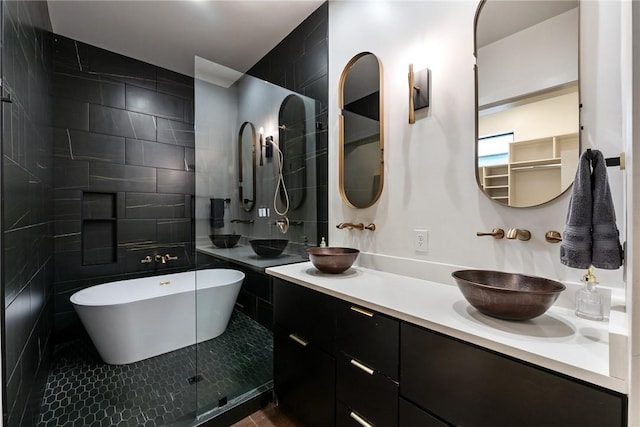 424 SE D St, Bentonville, AR 72712 - full bath featuring a freestanding tub, tile walls, double vanity, and a sink